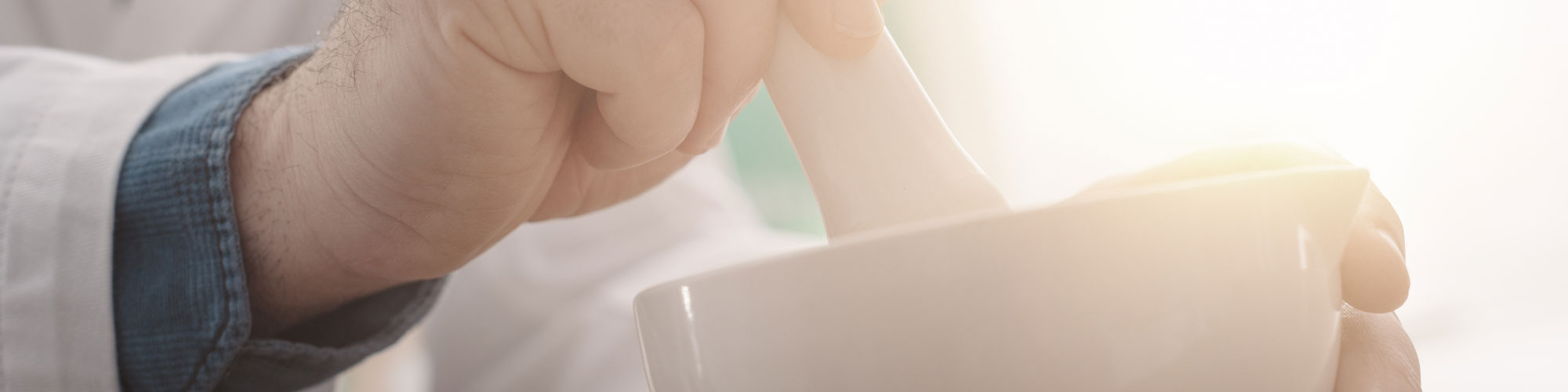Pharmacist Using Morter And Pestle